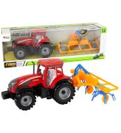 Ciągnik ze zgrabiarką na napęd frakcyjny czerwony